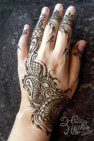 henna tattoo hand design application paste on
